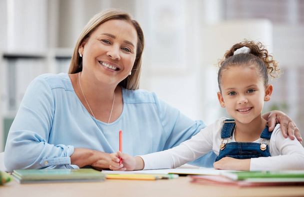 Our homework sessions are always successful. a grandmother helping her grandchild with her homework at home - Φωτογραφία, εικόνα