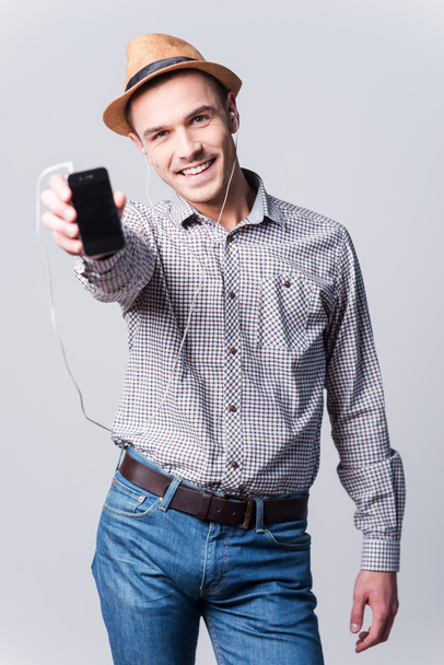 Man in fedora showing his MP3 player - Photo, Image