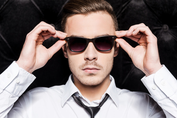 Man in shirt and tie adjusting his sunglasses - Photo, image
