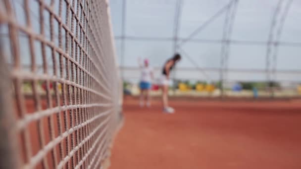 Tennis - two women tennis players warming up near the net. Mid shot - Кадры, видео