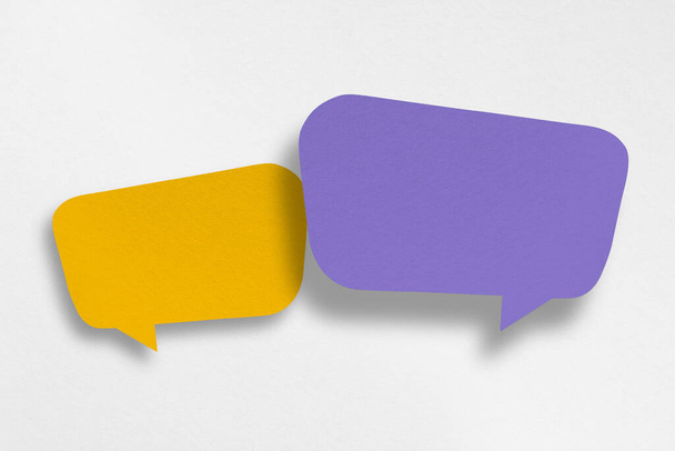 Purple and yellow paper cut speech balloon shapes isolated on white paper background. Design. - Fotó, kép