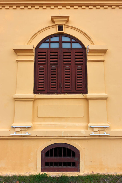 Starożytny żółty budynek architektury kolonialnej Istnieją piękne elementy dekoracyjne stiukowe, drzwi i okna. - Zdjęcie, obraz