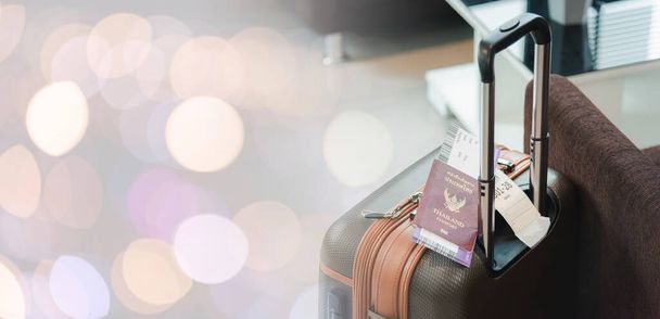 Close up Thailand passport on baggage luggage of tourist in the airport, documentation boarding pass ticket on travel suitcase pocket, Travel holiday concept - Photo, Image
