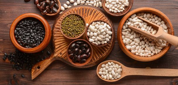 Different legumes on wooden background, top view - Valokuva, kuva