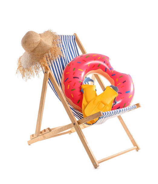Deck chair with hat, paddles and inflatable ring on white background - Fotó, kép
