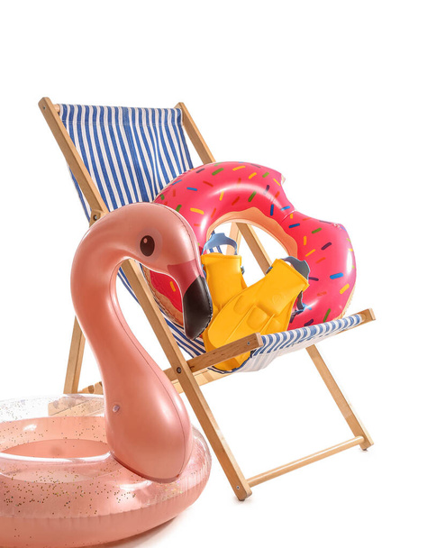 Deck chair with paddles and inflatable rings on white background - Valokuva, kuva