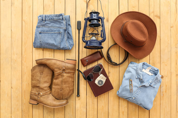 Accessories for travelling with whip on wooden background - 写真・画像