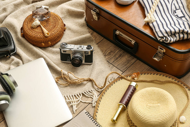 Accessories for travelling with photo camera on wooden background - 写真・画像