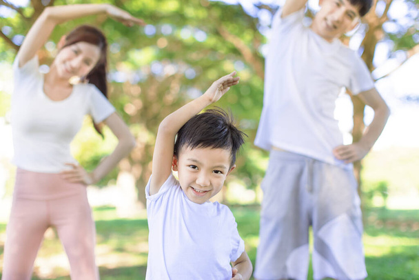Happy family life. Kid and parents  having Fun with sport day at outdoors.  - Valokuva, kuva