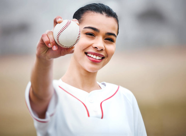 Time for a curve ball. Cropped portrait of an attractive young female baseball player standing outside - Фото, изображение