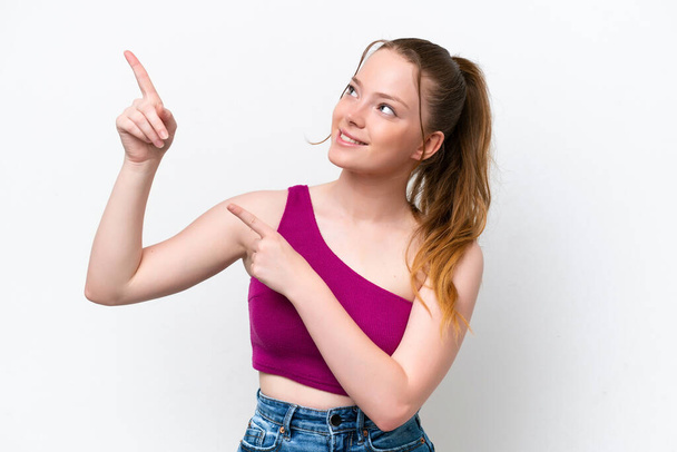 Young caucasian girl isolated on white background pointing with the index finger a great idea - Foto, imagen