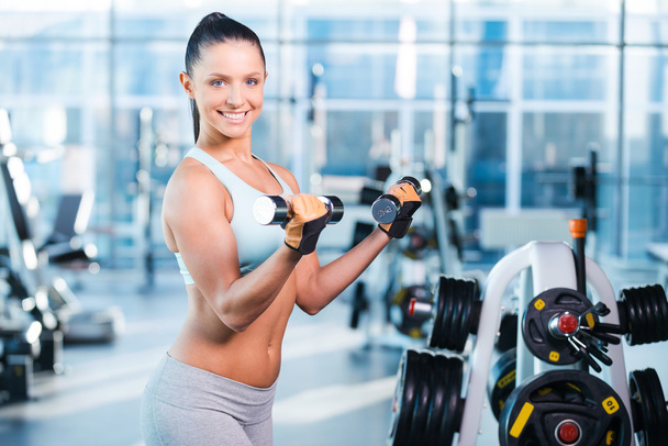 Woman exercising with dumbbells - Foto, immagini