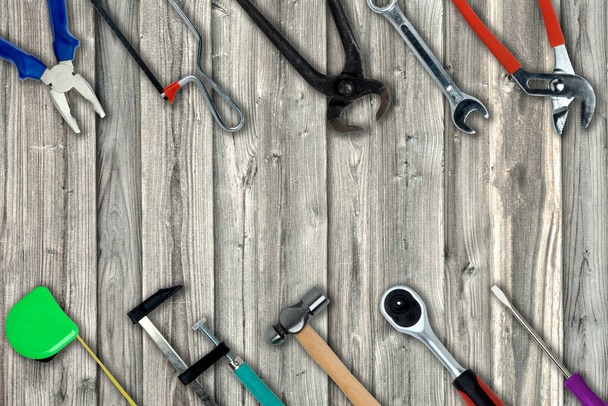 Topview of Different Work Tools on Wood Background- Stock Photo - Zdjęcie, obraz
