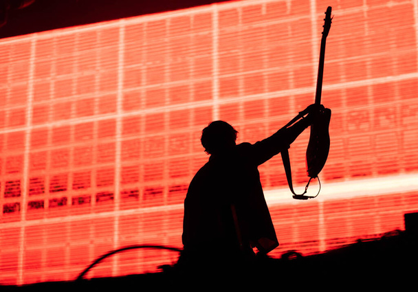 guitarist silhouette in stage lights - Fotó, kép
