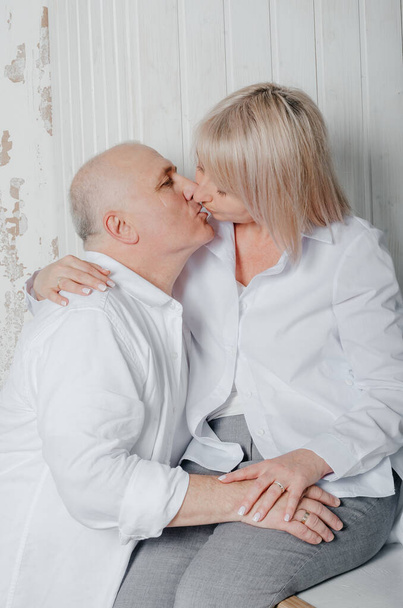 a man and his wife in white shirts in a photo studio - Foto, Imagen