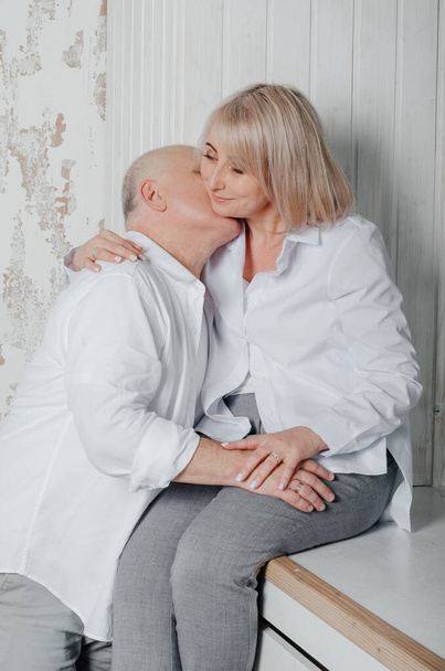 a man and his wife in white shirts in a photo studio - Photo, image