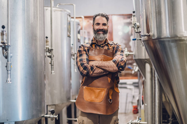 Portrait of man who is working at craft beer factory. Small family business, production of craft beer. - Φωτογραφία, εικόνα