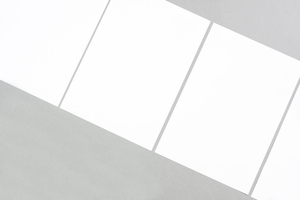 Empty white rectangle poster mockups lying diagonally on a gray background. - Foto, immagini