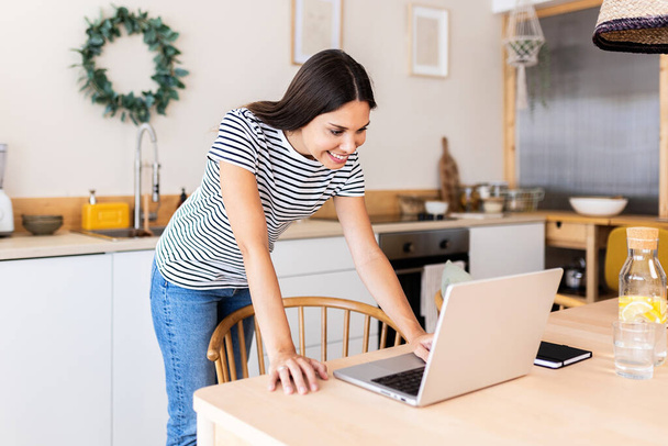 Young adult business woman working remotely on laptop computer from home - Φωτογραφία, εικόνα