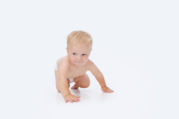 Cute little baby in a diaper on a white isolated background - Φωτογραφία, εικόνα