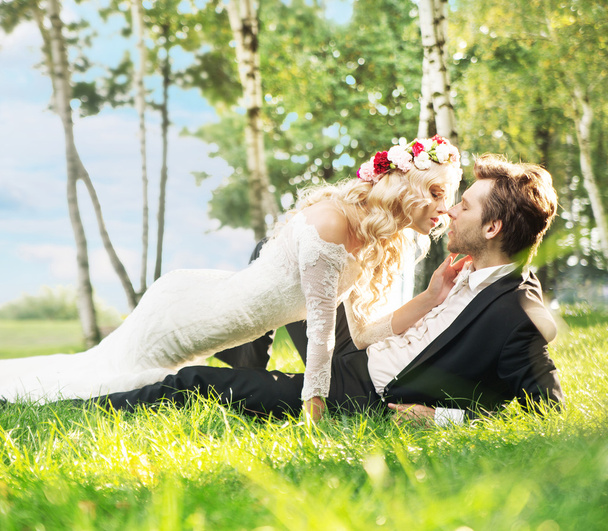 Marriage couple lying on the lawn - 写真・画像