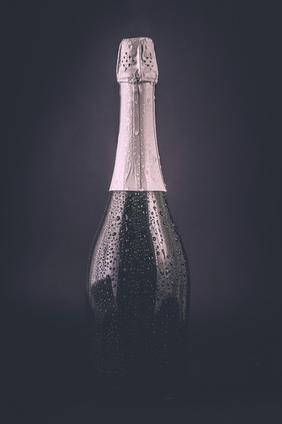 bottle of champagne in the drops of water  - Photo, Image