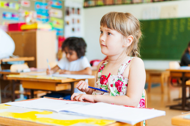 Cute little girl working in a classroom - Photo, Image