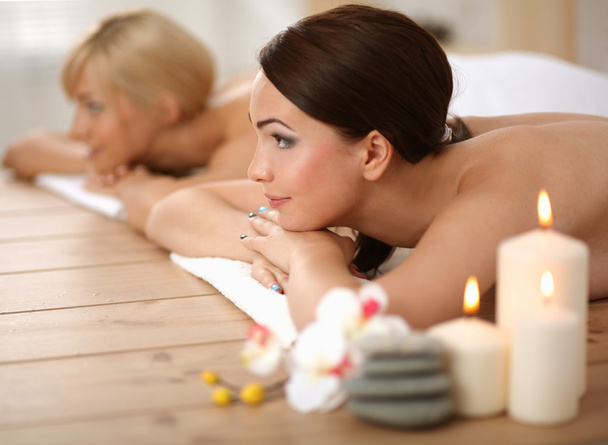 Two young beautiful women relaxing and enjoying at the spa center - Foto, immagini