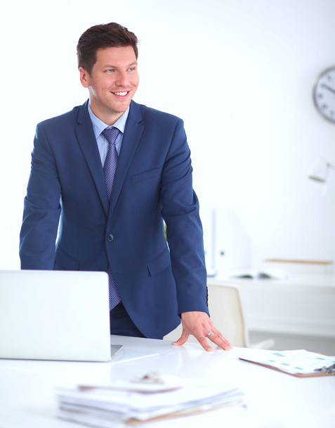 Confident successful young businessman leaning arms on his desk - Foto, immagini
