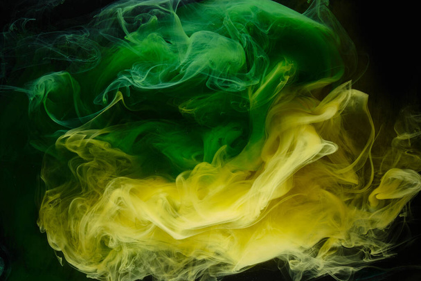 Liquid fluid art abstract background. Green, yellow dancing acrylic paints underwater, space smoke ocean, color explosion - Φωτογραφία, εικόνα