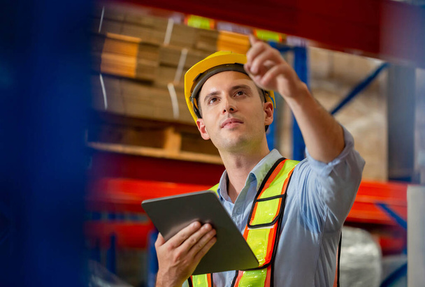 Warehouse worker with digital tablet checking inventory in warehouse, Worker working in factory warehouse - Φωτογραφία, εικόνα