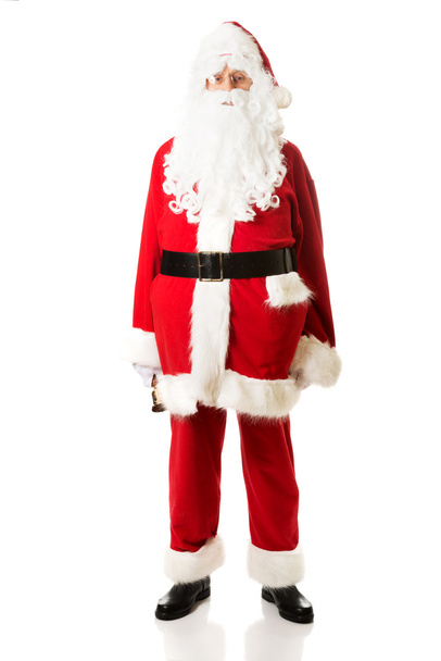 Full length Santa Claus holding a bell - Фото, изображение