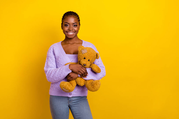 Photo of cheerful adorable person arms hold teddy bear toy empty space isolated on yellow color background. - Fotoğraf, Görsel