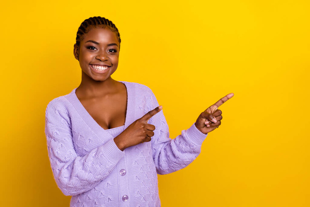 Photo of pretty positive person indicate fingers empty space blank isolated on yellow color background. - Fotó, kép