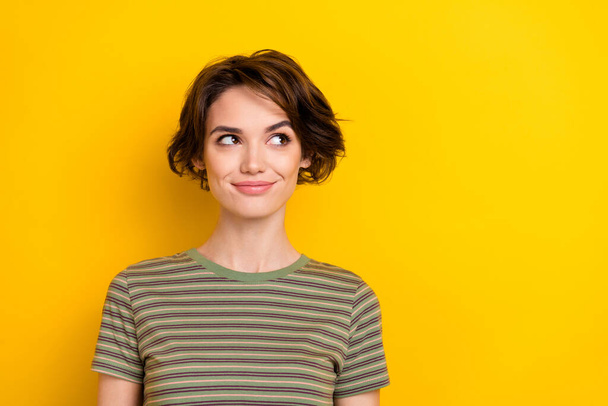 Photo of cheerful cute nice young attractive gorgeous woman think about shopping isolated on yellow color background. - Фото, изображение