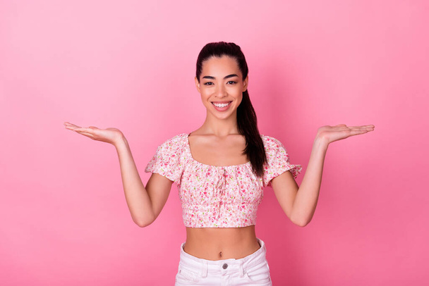 Photo of lovely young lady hold empty space wear top isolated on pink color background. - Photo, Image