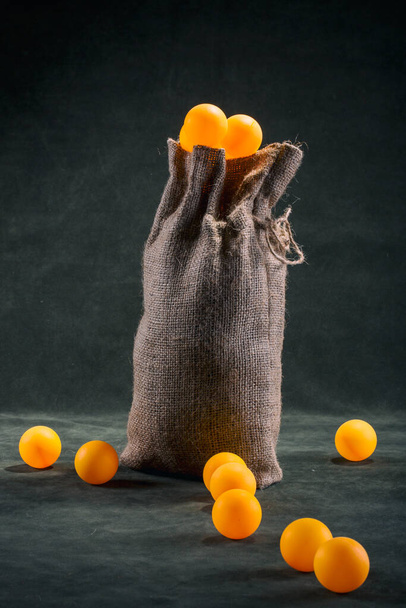 Still life with a full bag of orange balls - Photo, Image
