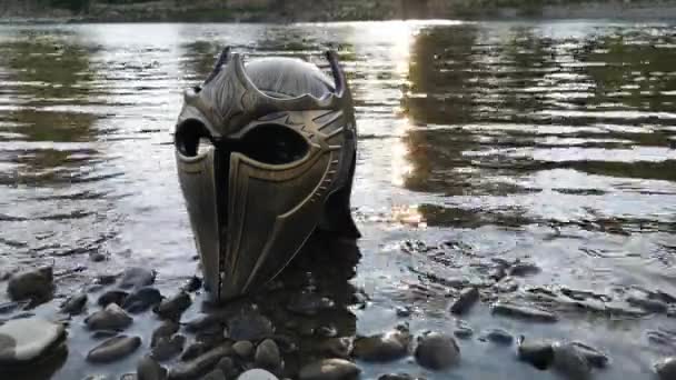 Metaforyczna instalacja na górskiej rzece z kaskiem gladiatorskim - Materiał filmowy, wideo