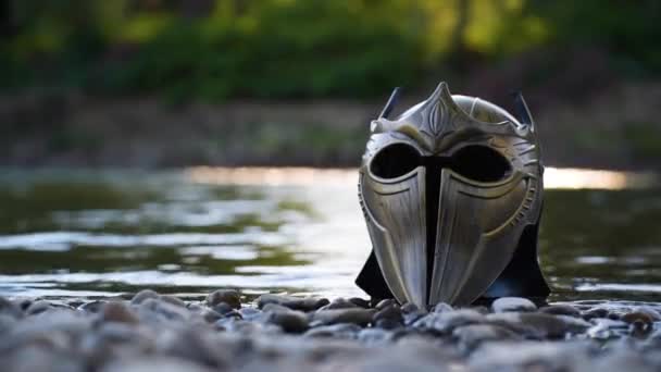 Metaphorical installation on a mountain river with a gladiatorial helmet - Imágenes, Vídeo