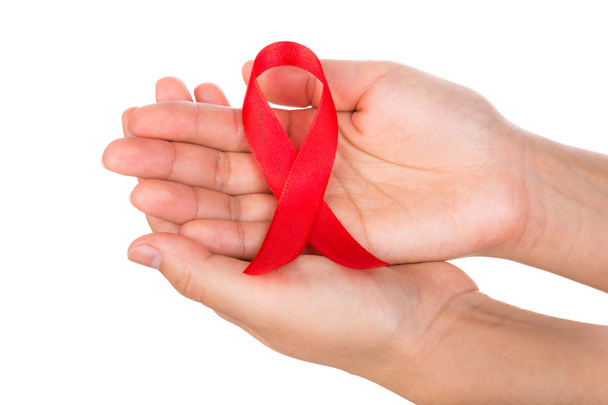 AIDS ribbon in hand isolated on white background - Φωτογραφία, εικόνα