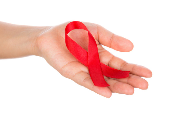 AIDS ribbon in hand isolated on white background - Фото, зображення