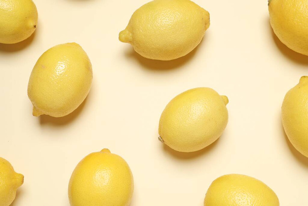 Fresh ripe lemons on beige background, flat lay - 写真・画像