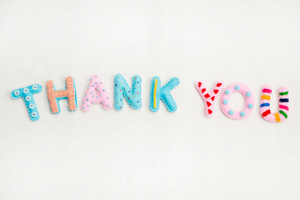 Stuffed felt letters with decorations. Word "Thank you" on isolated neutral background. Handmade crafts. Flat lay. - Fotoğraf, Görsel
