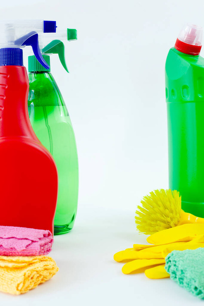 Colorful cleaning set for different surfaces in kitchen, bathroom and other rooms. Empty place for text or logo on isolated background. Cleaning service concept. Early spring regular clean up. - Foto, imagen