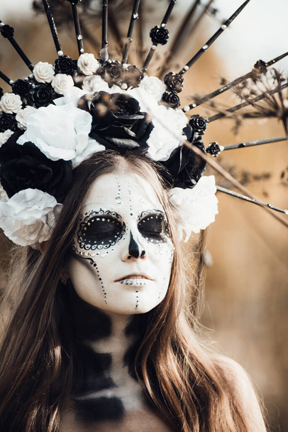 Closeup portrait of Calavera Catrina in black dress. Sugar skull makeup. Dia de los muertos. Day of The Dead. Halloween. - Фото, изображение