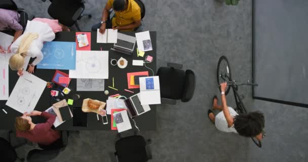 A young productive team of employees working together in the office. Multitasking colleagues collaborating, networking, and developing new efficient ideas for a successful startup company. - Кадры, видео
