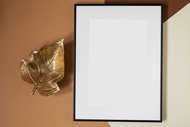 Black picture frame with decorations. Mock up for your photo or text. Place your work, print art, white background. Photo realistic 3d illustration. Brown background - Zdjęcie, obraz