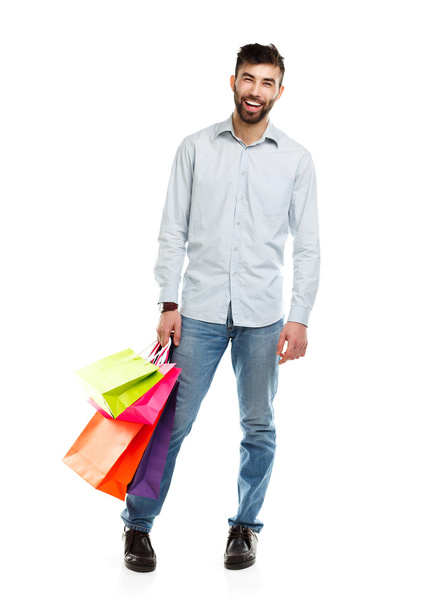 Man holding shopping bags. Christmas and holidays concept - Фото, изображение