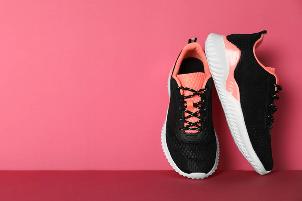 Pair of stylish sport shoes on pink background, space for text - Foto, Imagen