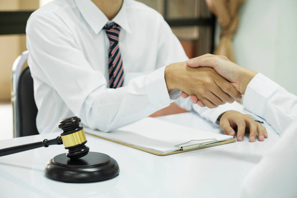 Businessman Shaking hands with Professional male lawyer after discussing good deal of contract in courtroom, Concepts of law, Judge gavel with scales of justic, Legal services advice at the law office - Fotoğraf, Görsel